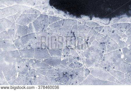 Frozen Puddle With Broken Ice. Winter Season.