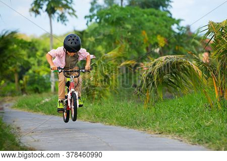 Country Cycling Walk. Young Rider Kid In Helmet And Sunglasses Riding Bicycle. Happy Child Have Fun 
