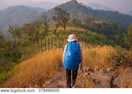Young Woman Hiking Enjoying In The Mountains With Backpack At Khao Chang Puak Mountain Thailand