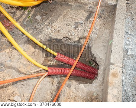 Road Work For The Installation Of Fiber Optic Cables For Telecommunications. Safety Tube With Cables