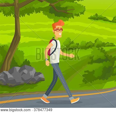 Young Red-haired Man In Glasses With Backpack Traveling Alone. Smiling Guy Walking At Road At Backgr