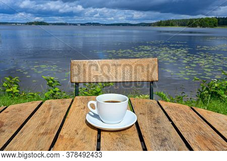 Coffee Cup On Wooden Table Near Lake