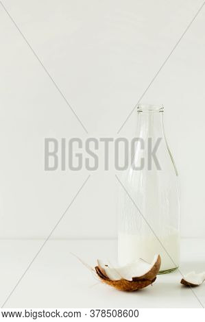 Glass Bottle Of Delicious Fresh Homemade Coconut Kefir Or Yogurt On White Background.non-dairy Lacto