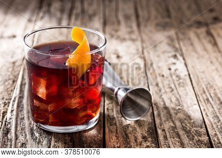 Boulevardier Cocktail And Orange Zest On Wooden Table. Copy Space