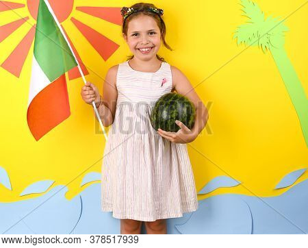 Little Girl On A Bright Background With The Italian Flag Holding A Fruit Basket In Her Hands. The Co