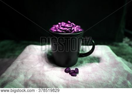 Black Coffee Cup With Coffee Beans On A Table