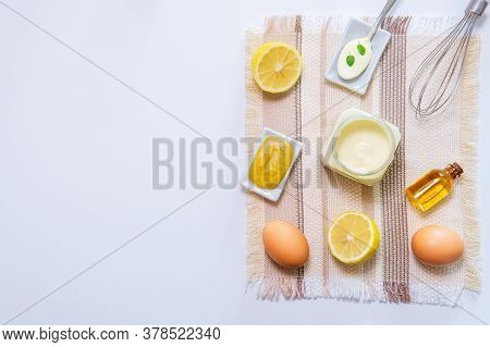 Ingredients For Making Homemade Mayonnaise Sauce. Mustard, Gas, Lemon, Vegetable Oil. On A White Bac