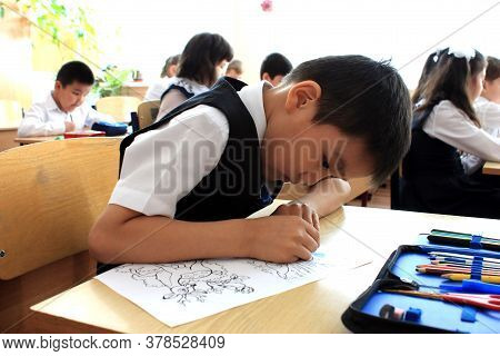 Moscow, Russia - September 1, 2017: Schoolboy, Pupil Sitting At The Desk In Class At School, Traditi