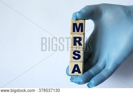Mrsa Is An Acronym On Cubes Held By A Hand In A Blue Glove. Medical Concept.
