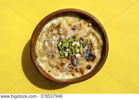 Traditional Arabic, Egyptian, Eastern Dessert Om Ali. Top View. Egyptian Bread Pudding In A Brown Bo