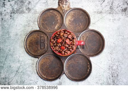 Old Mini Pancake Pan And A Cup With Coffee Beans