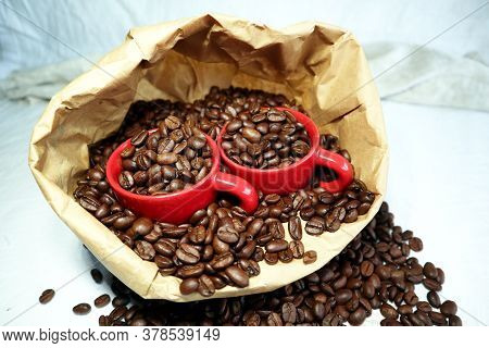 Ceramic Cup In A Paper Bag With Coffee Beans