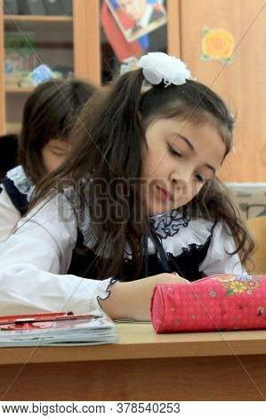 Moscow, Russia - September 1, 2017: Schoolgirls Sitting At The Desk In Class At School, Traditional 
