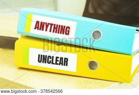 Two Office Folders With Text Anything Unclear