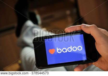 Badoo Application On The Smartphone In Mans Hand. Man Laying And Using Application For Dating And Me