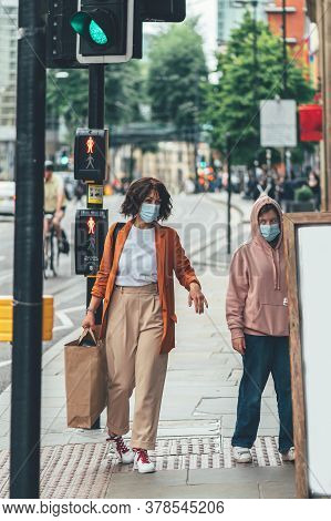 Mum And Daughter In Face Mask Are Shopping In City Centre Of Manchester, England, Uk , New Normal