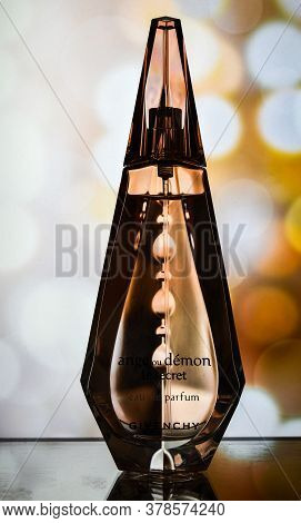 Zhytomyr, Ukraine - June 2, 2020. A Clear Orange Glass Spray Bottle Of Givenchy Ange Ou Demon Le Sec