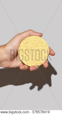 Woman Hand Hold Remove Makeup Pad. Yellow Cosmetology Sponge For Skincare Routine. Unmakeup Procedur