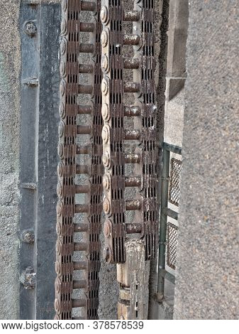 Old Rusty Machine Part Of Chain Gear In River Weir. Hydrodynamic Power Plant Part Change Possition O