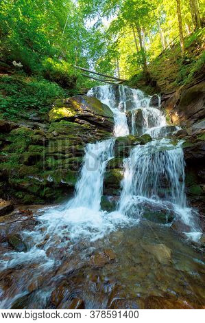 Great Water Fall In The Forest. Beautiful Nature Landscape. River Among The Rocks. Fresh Summer Scen