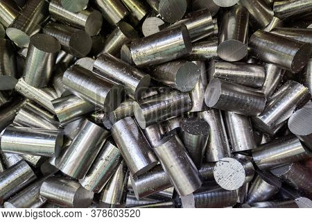 A Pile Of Saw Cutted Stainless Steel Rods With Metal Sawdust - Closeup With Selective Focus