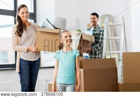 mortgage, family and real estate concept - happy mother, father and little daughter with stuff in boxes moving to new home