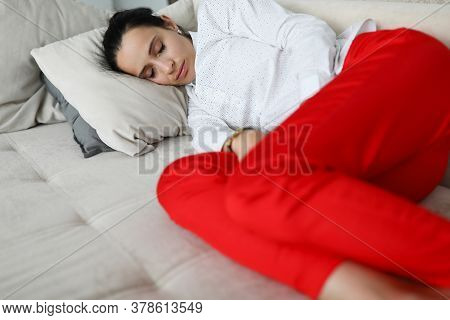 Woman In Business Clothes Is Sleeping On Couch. Overwork And Stress In The Workplace Concept