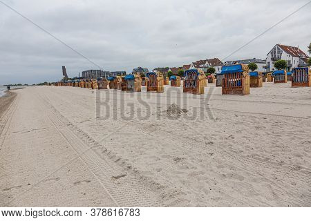Roofed Wicker Beach Chairs At Beach Of German Village Laboe In Summer