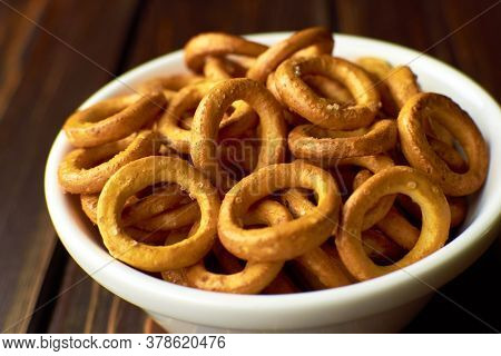 Russian Bagels With Salt Closeup In White Ceramic Bowl On Dark Rustic Table