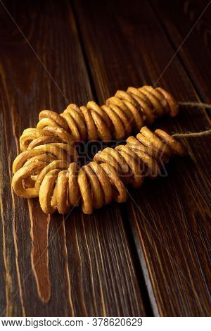 Wheat Bagels On A Rope On Dark Wooden Table. Traditional Russian Food.