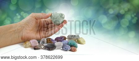 Crystal Healer Holding Green Puff Heart Stone - Female Hand Offering A Heart Shaped Crystal With A S