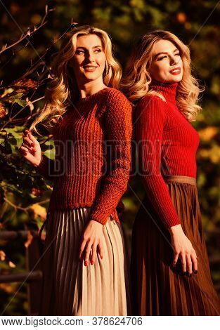 Freedom. Girl Friends Walk In Park. Sunny Day With Fallen Leaves. Fall Fashion Season. Pleated Trend
