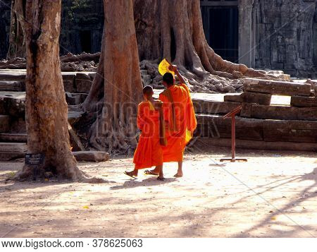 Angkor Wat, Siem Reap, Cambodia, April 6, 2016: Two Young Buddhist Monks On A Hot Day In Angkor Wat 