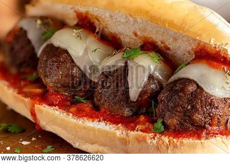 Closeup Of A Meatball Sandwich With Tomato Sauce And Cheese On A Hoagie Roll