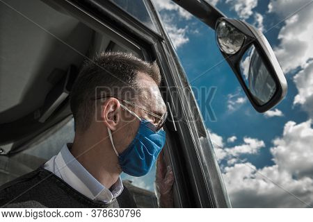 Caucasian Shuttle Bus Driver In His 40s Wearing Face Mask During Pandemic. Public Transportation Ind