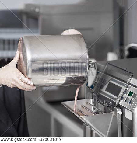 Women Hands In Gloves Preparing Chocolate Ice Cream -  Mixed Milk Base Into The Ice Cream Machine At