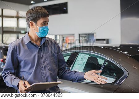 Asian Saleman Wear Surgical Mask Working In Inspector Checking Writing On Clipboard In Garage Of Dea