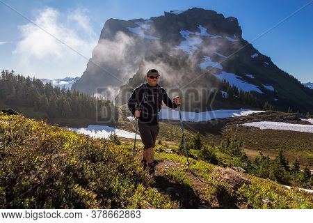 Adventurous Man Hiking In The Canadian Mountains During A Sunny Summer Morning. Taken On The Trail T
