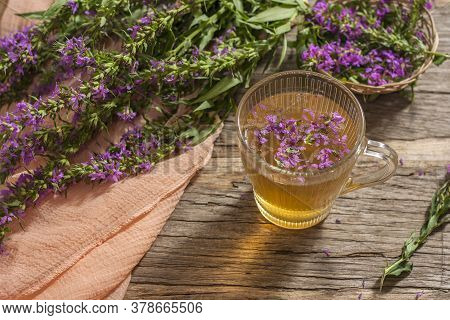 Fireweed Is A Healthy Herbal Tea. Mug Of Traditional Russian Drink Ivan Tea On A Wooden Background W