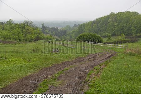 Landscape With Dirt Rural Road Among The Green Hills At Countryside. Summer Ukrainian Nature. Surrou