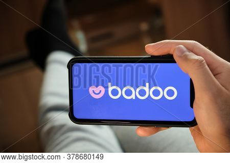 Badoo Application On The Smartphone In Mans Hand. Man Laying And Using Application For Dating And Me