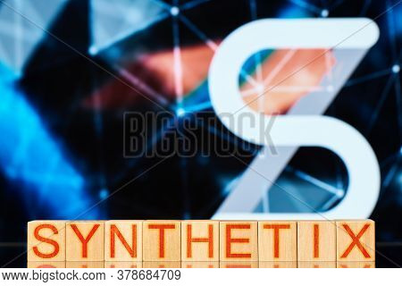 Synthetix Concept. Wooden Blocks With The Inscription Synthetix On The Background Of The Cryptocurre