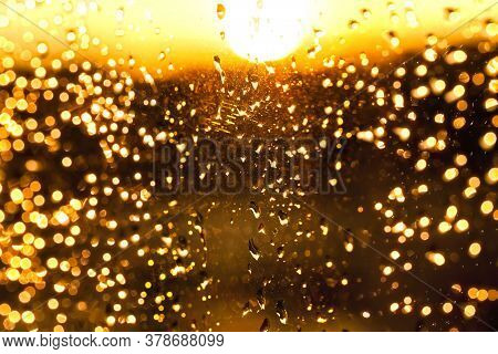 Beautiful Yellow Bright The Clouds During Sunset Or Sunrise, The Rain Drops On The Glass , Out Of Fo