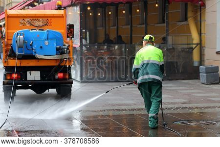 Sidewalk Washing With Water From A Hose, Griboyedov Canal Embankment, Saint Petersburg, Russia July 