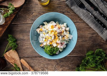 Top View On Russian Salad With Crab Sticka And Corn Dressed With Mayonnaise
