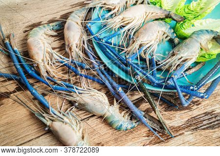 Top Down Fresh Tiger Prawns In A Plate With Ice On A Wooden Textured Background Shrimps Or Prawn Raw