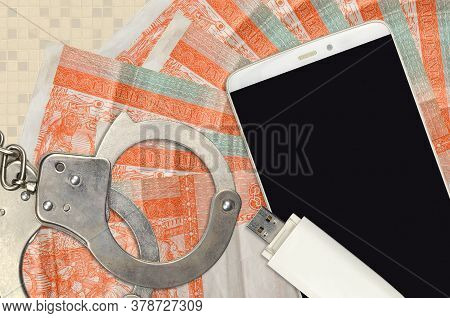 3 Cuban Pesos Convertibles Bills And Smartphone With Police Handcuffs. Concept Of Hackers Phishing A