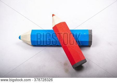 Blue And Red Pencil Stands On A White Background