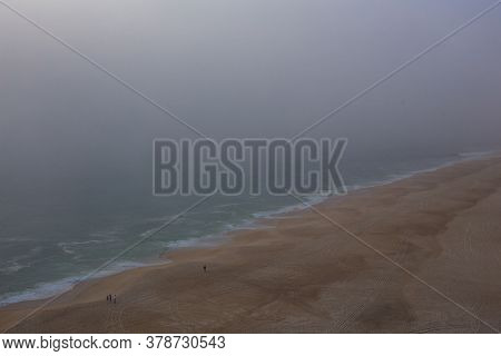 Sea And Sandy Beach In Dense Fog, Autumn Day