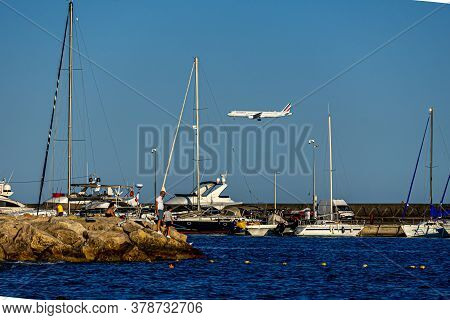 Cagnes- Sur-mer, France 24.07.2020. Flying Plane Over The Sea With Yachts. High Quality Photo